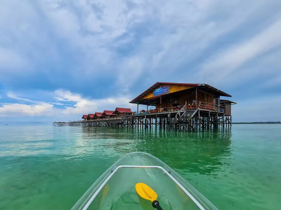 Guests enjoying sea kayaking in the calm turquoise sea Pavalintang Resort